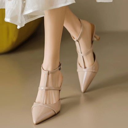 A woman wearing beige leather ankle strap slingback heels