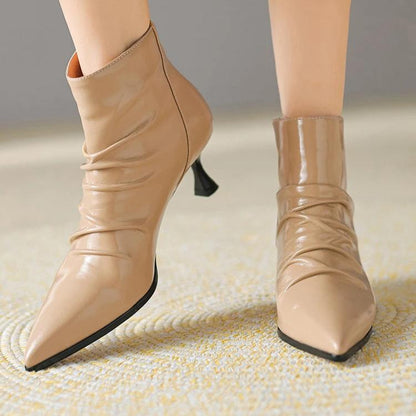 Woman wearing ankle boots in beige patent leather