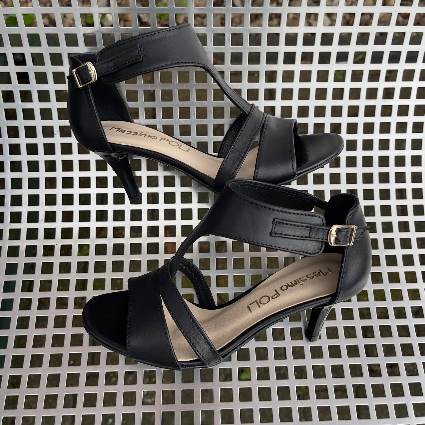 Small size black leather strappy heels set on a kitten heel