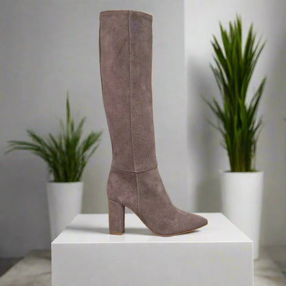 Knee high beige suede boots set on a high heel