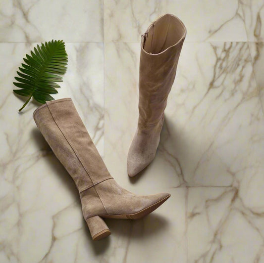 Tan suede leather knee boots on the floor