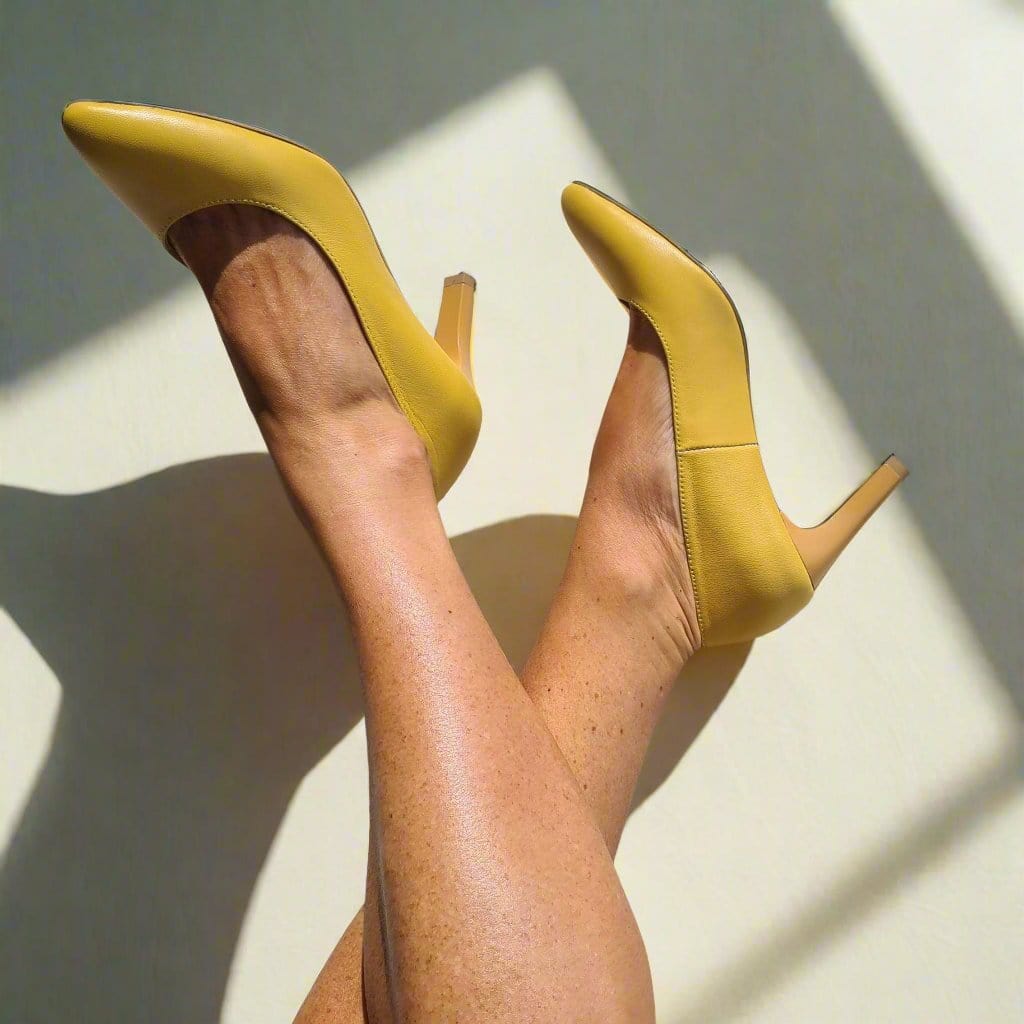 Woman wearing kitten heels in yellow leather