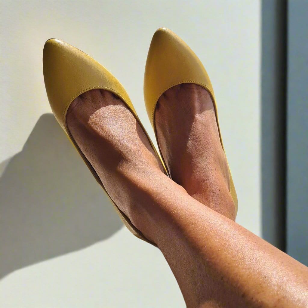 Woman wearing kitten heels in yellow leather