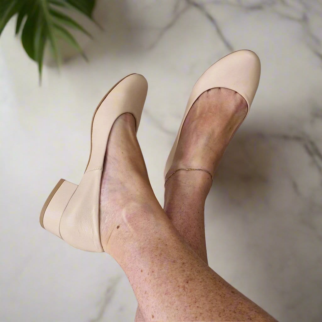 Woman wearing nude leather court shoes