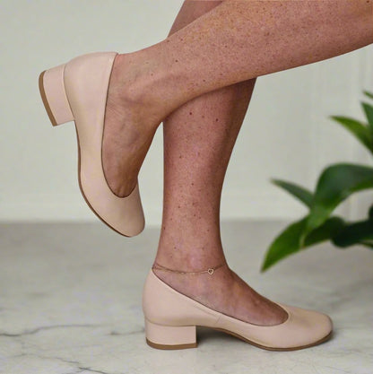 Woman wearing small size nude leather pump shoes