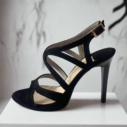 Black suede strappy heels with a red sole, shown from a side and top view on a white background.