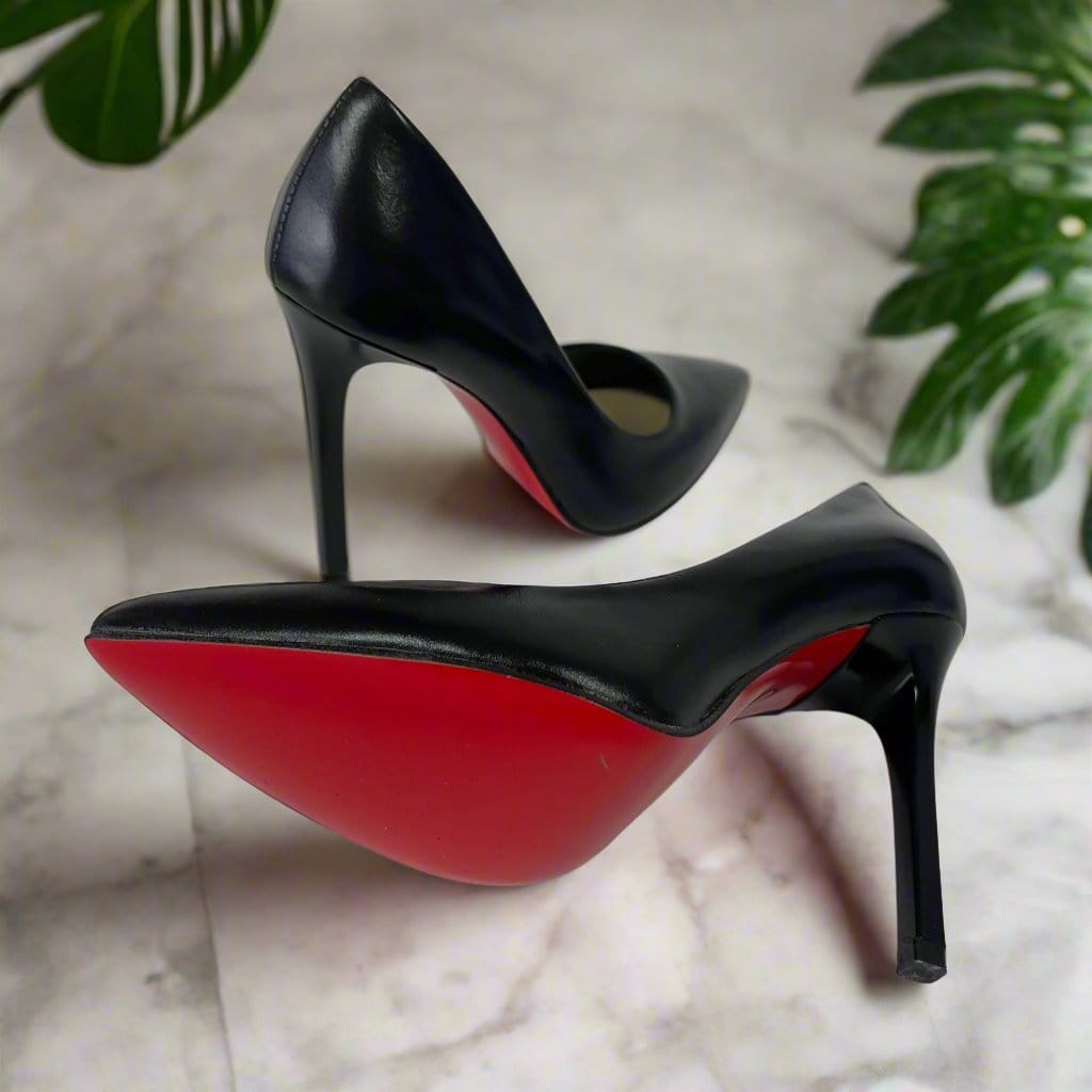 Black leather stilettos with a red sole