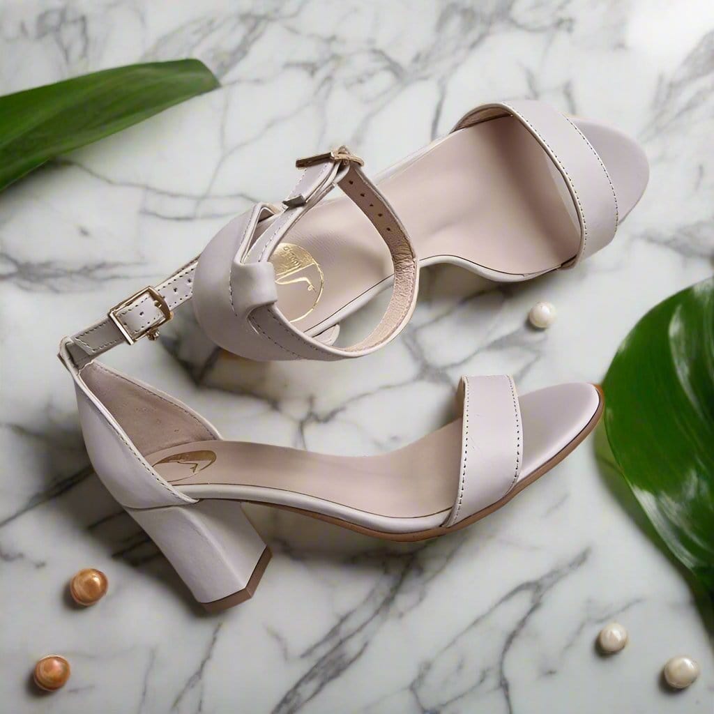 Nude leather sandals set on a block heel with a gold buckle