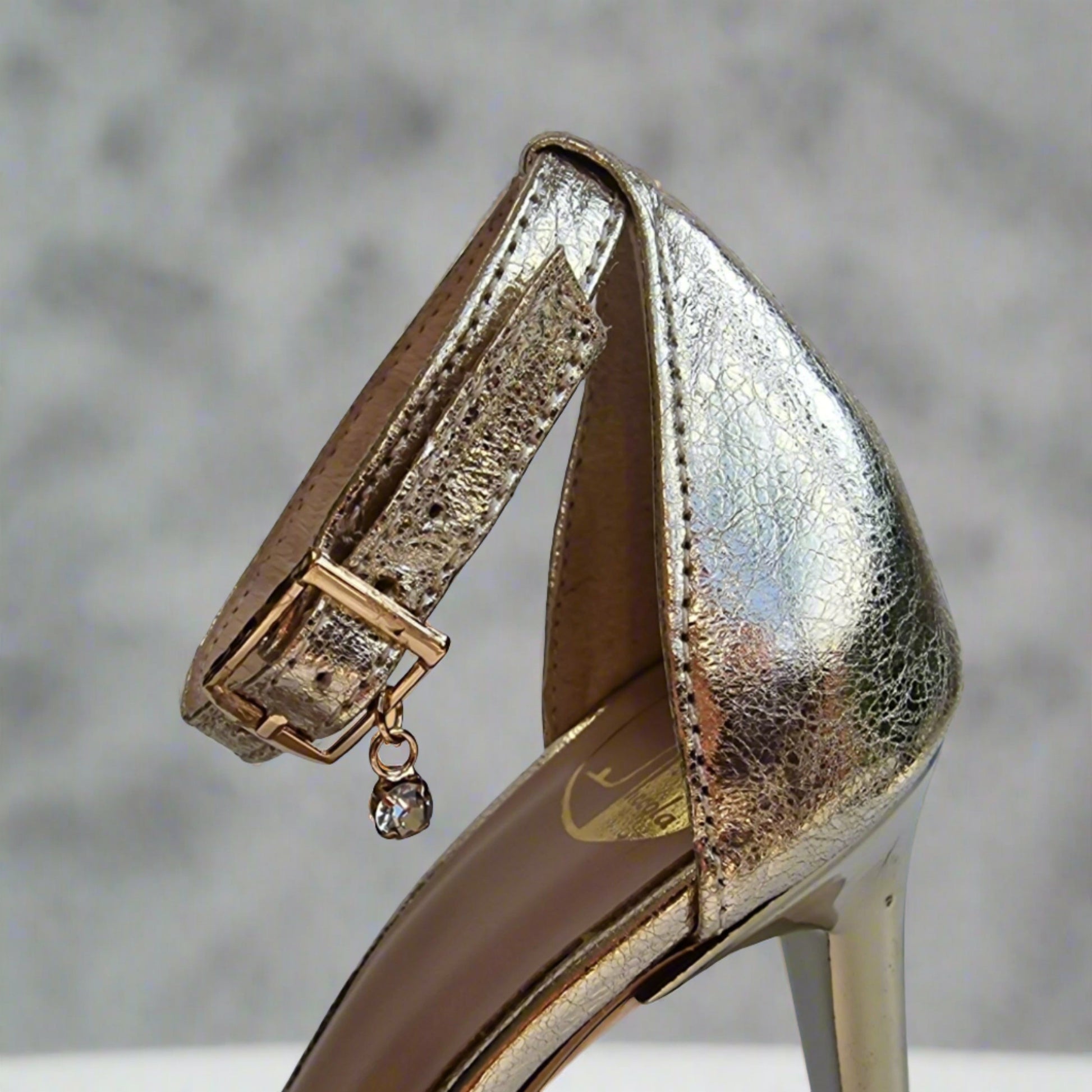 Ankle strap with a buckle fastening and a crystal brooch 