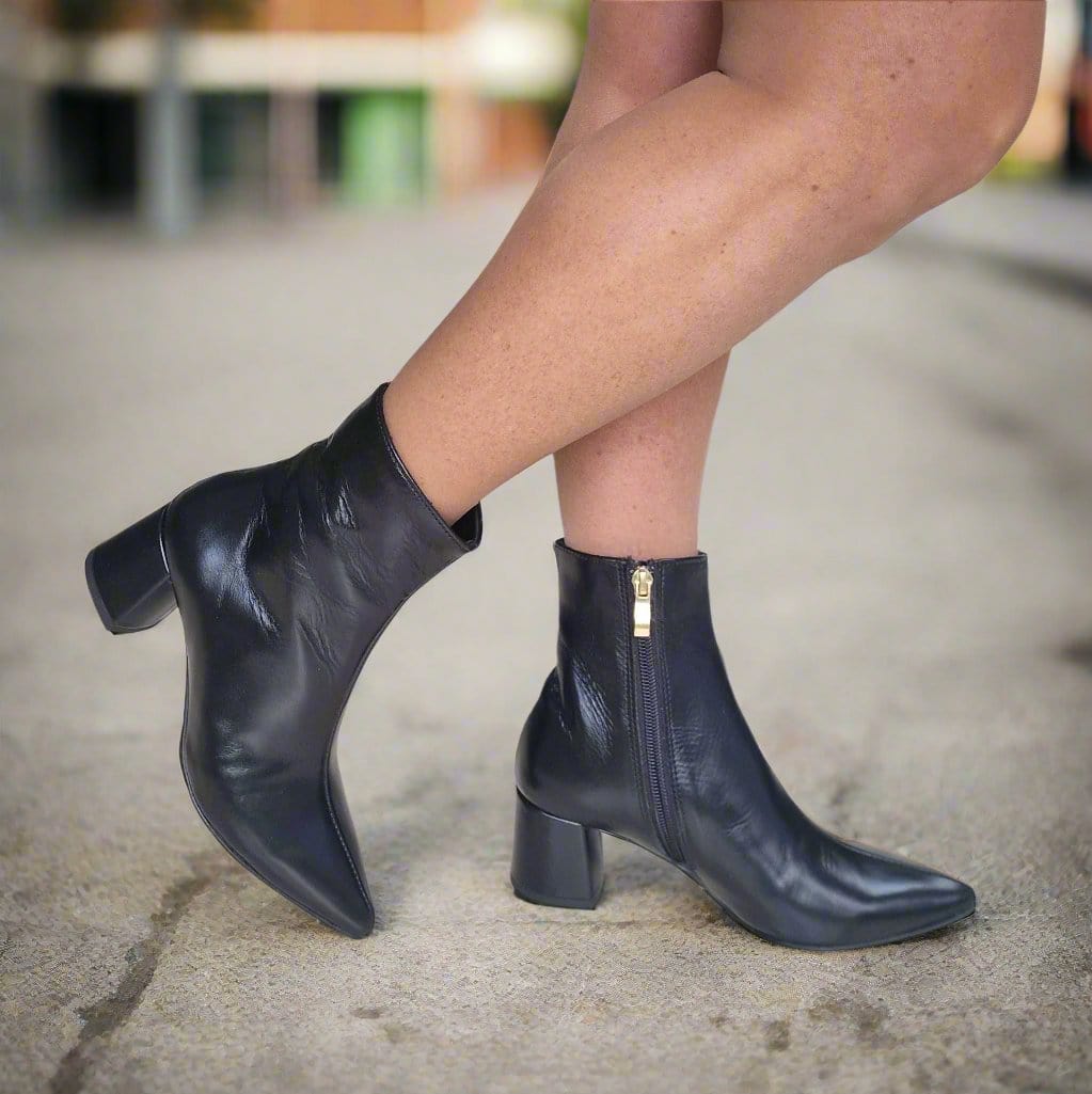 Block heel pointed toe ankle boots in black with a gold zip