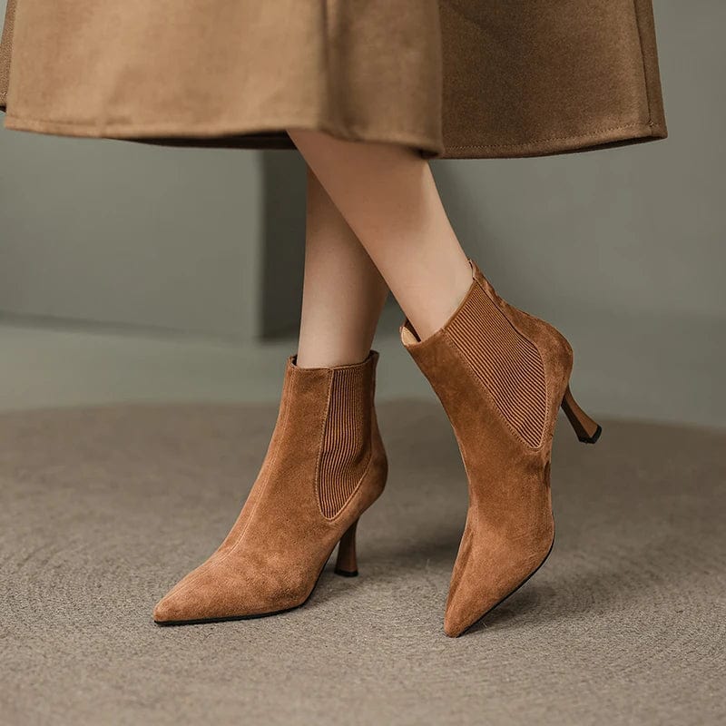 Woman waring brown suede ankle boots set on a small heel