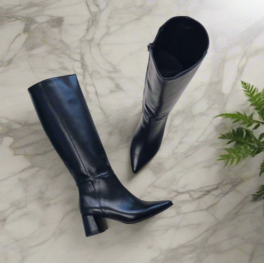 Black knee high boots with a side zip and pointed toe