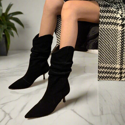 Black suede slouchy boots set on a mid heel