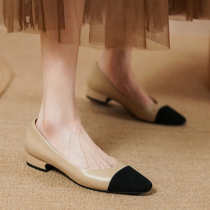 Woman wearing brown leather kitten heel ballerina pumps with a black suede tip