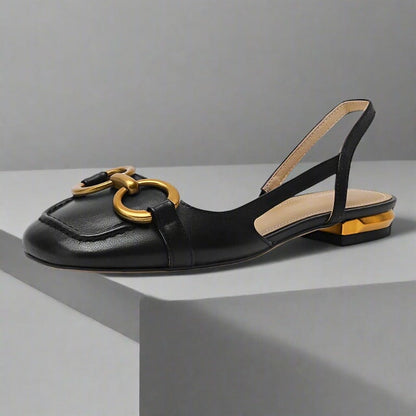 Black leather slingback sandals with a gold decoration