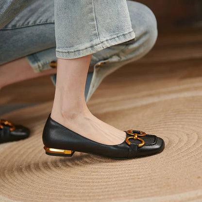 Woman wearing blue denim and black ballerina pumps