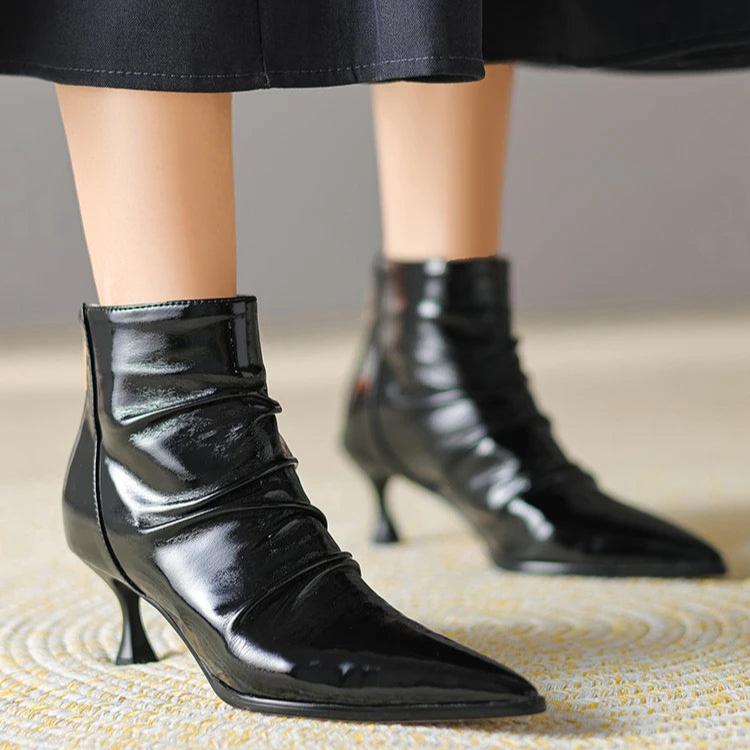 Woman wearing ruched black ankle boots