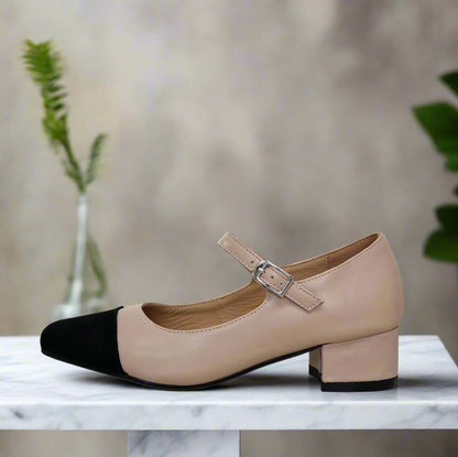 Mary janes style shoes in nude leather with black cap and a strap