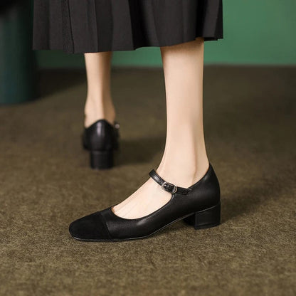 Woman wearing black mary jane shoes with a foot strap in black leather 