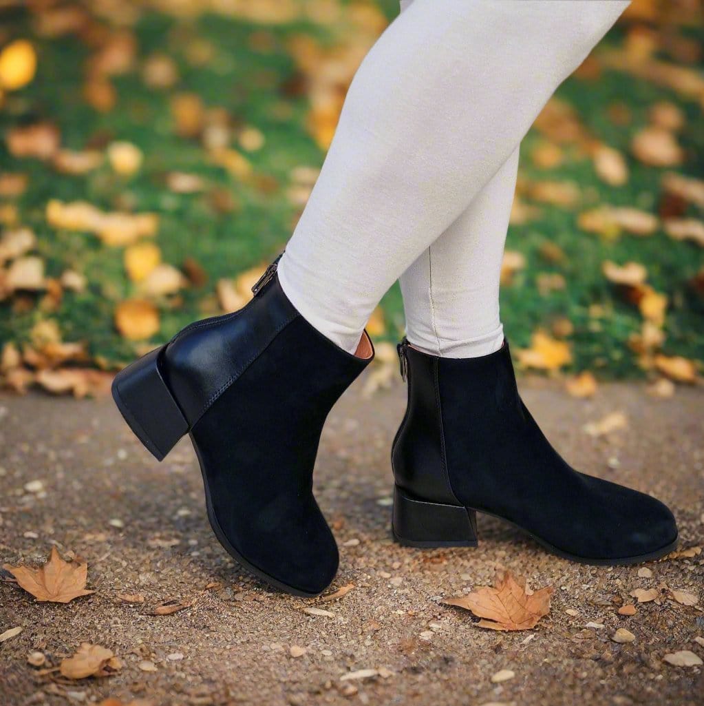 woman wearing petite size ankle boots in black leather and block heel