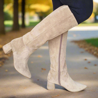 Woman wearing knee high suede boots in tan